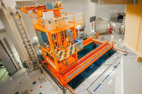 A crane above a cooling pond for spent fuel rods below the reactor dome at the Emsland nuclear power plant of the RWE Power AG