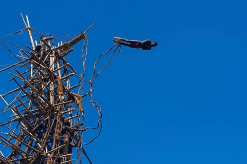 Man jumping from a bamboo tower