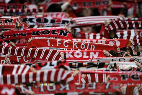 Cologne fans holding their scarves up