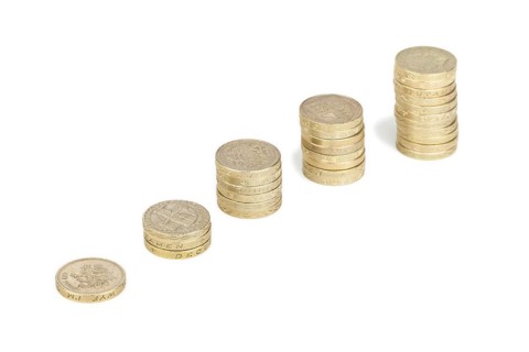 Piles of UK sterling pound coins