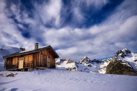 Alpine hut in a mountain landscape in winter