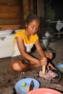 Papuan woman preparing food