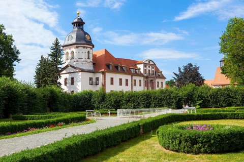 Schlosspark palace gardens with Schloss Christiansburg Palace and the Baroque Cross Church of St. Trinitatis