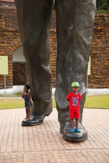 Children at the feet of the huge Nelson Mandela statue in front of the Union Buildings government buildings