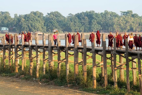 Locals and monks on a teak bridge