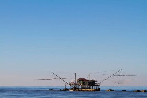 Fisherman's house with nets over the sea in Marina di Pisa