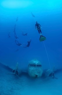 Freedivers at plane wreck Douglas Dakota