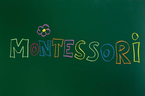 Montessori' written with chalk on a blackboard