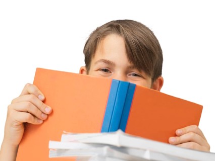 Schoolboy behind a school book