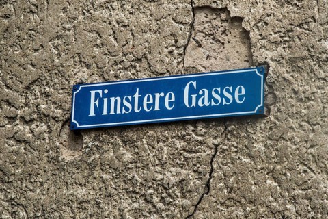 Street sign Finstere Gasse or Dark Alley