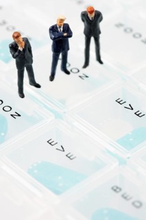 Businessmen miniature figurines on pill box