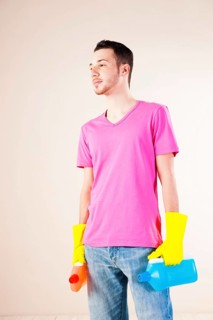 Man holding bottles of cleaning agents in his hands