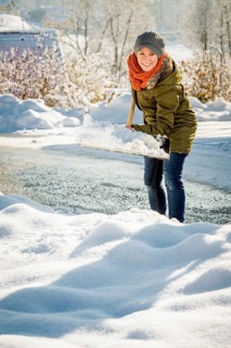 Woman shovelling snow