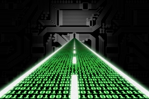Road made of binary code leading towards a stylized circuit board