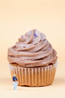Miniature figurine standing in front of muffin