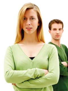 Young couple standing with their arms crossed
