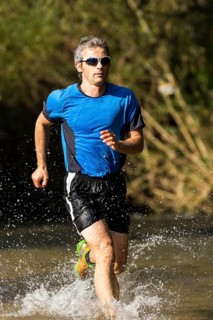 Jogger running through a stream