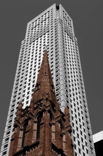 Old tower of the Presbyterian Church in front of a skyscraper