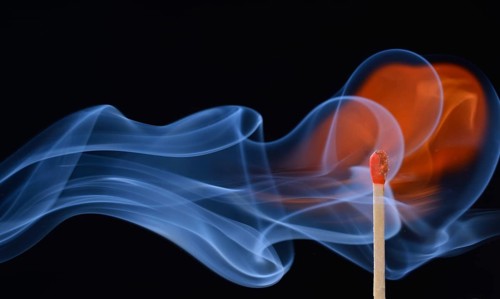 Lit matchstick with a flame and smoke