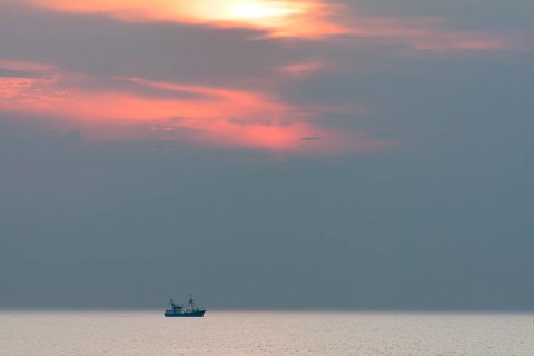 Shrimp boat at sunset