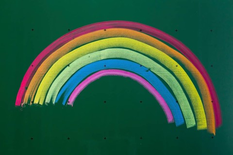 Rainbow drawn with chalk on a blackboard
