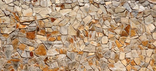 Wall of many beige natural stones