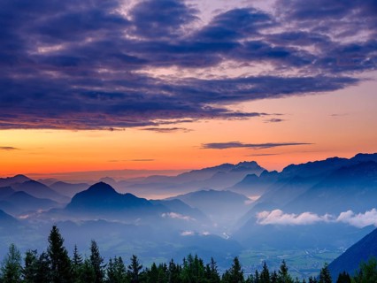 Blue mountain silhouettes at sunrise