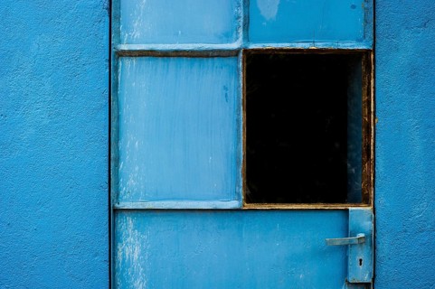 Blue-painted door with a window
