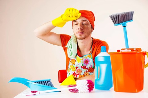 Young man looking exhausted after doing the the cleaning
