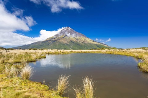 Mountain lake with the Mount Taranaki volcano