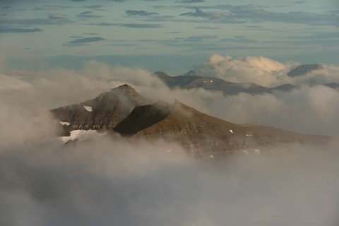 Mountain landscape in the evening light with looming clouds