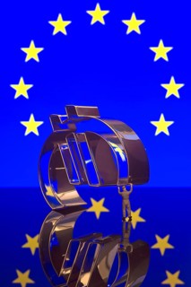 Miniature figure of a worker is carrying the Euro-symbol