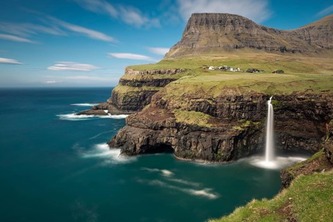 Waterfall on the cliffs near a village