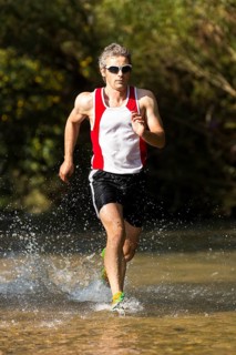 Jogger running through a stream