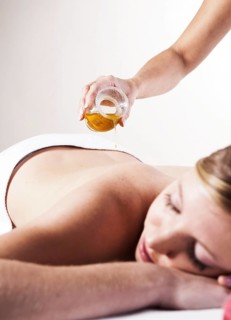 Young woman about to receive a massage with oil