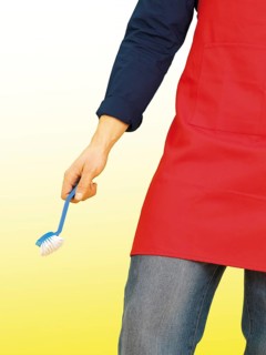 Young man wearing an apron while doing the housework