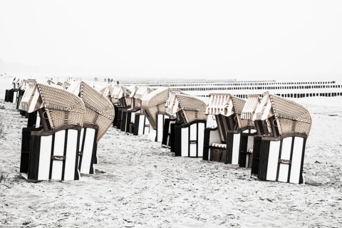 Roofed wicker beach chairs on the beach