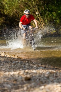 Mountain biker crossing a stream