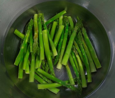Fresh green Garden asparagus (Asparagus officinalis) in an aluminium bowl