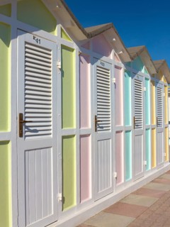 Pastel coloured beach cabins