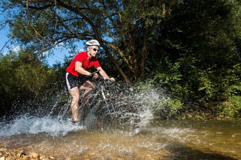 Mountain biker crossing a stream
