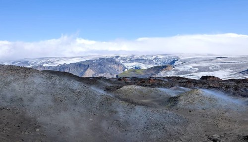 View across new lava fields created by a volcanic eruption in 2010 to the Myrdalsjokull glacier