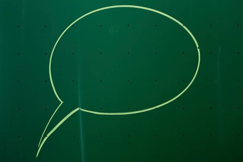 Speech bubble drawn with chalk on a blackboard
