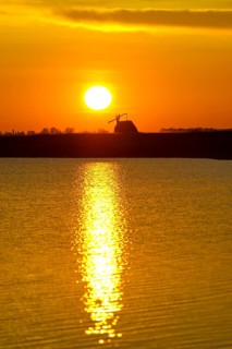 Sunrise with drawing well at Darscho-Lacke or Warmsee Lake