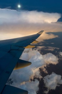 View from a Boeing 747-400 of a storm front at full moon