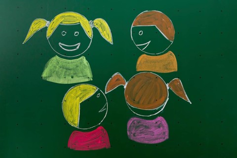 Four children drawn with chalk on a blackboard