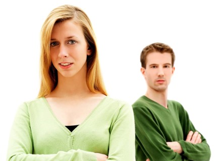 Young couple standing with their arms crossed