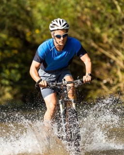 Mountain biker crossing a stream