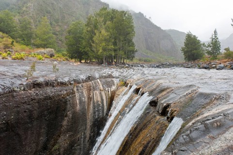 Mountain stream flowing into a crevice