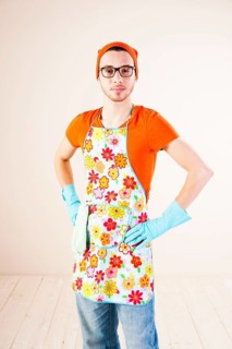 Young man wearing an apron and cleaning gloves